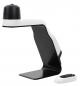 Preview: The image shows a modern table lamp in black and white. It has a creative, curved shape and a round top. Next to the lamp is a small remote control.