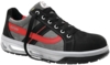 Preview: The shoe is a sporty sneaker with a gray and black surface. It features red accents, a padded tongue, and a textured sole for good grip. The laces are black.