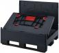 Preview: The image shows a black transport box with a red clasp. The box has a foldable top that is slightly open, and a sturdy base structure.