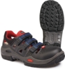 Preview: The image shows a sturdy shoe with an open design. It is predominantly black, with red and blue accents and three Velcro straps. The sole is textured and slip-resistant.