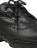 Preview: The image shows a black shoe with a flat sole and light-colored laces. The surface is smooth and has several seams that give it a sporty appearance.