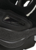 Preview: The image shows a part of a black sports shoe. The sole is thick and textured, with smooth and rough areas. There are cutouts on the side that give it a dynamic shape.