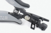 Preview: The image shows a pair of pliers with gray and black handles. It features a spring mechanism to open the pliers and a special device on the head for precise tasks.