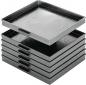 Preview: The image shows several black plastic trays stacked on top of each other. The top tray is slightly shifted and has two handles on the sides. The trays are smooth and have a slight shimmer.