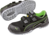 Preview: The image shows fashionable black sports shoes with green accents. They have a non-slip, gray sole and two wide Velcro straps on the top.