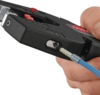 Preview: The image shows a hand holding a black tool used for stripping wires. A blue wire is inserted into the tool and is currently being processed.