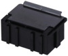 Preview: The image shows a small, rectangular box made of black plastic. It has a smooth top and vertical grooves on the sides. The lid is flat with a small raised area.