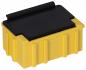 Preview: The image shows a rectangular, yellow plug or a box with a black cover on top. The sides are textured with vertical grooves. The shape is compact and sturdy.