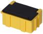 Preview: The image shows a rectangular container that is predominantly yellow, with a black lid. It has rounded edges and vertical grooves on the sides.