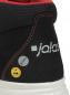 Preview: The image shows the upper part of a black work shoe with red elements. A "jalas" logo is visible, as well as safety symbols for ESD. The seams are meticulously crafted.