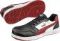 Preview: The image shows a pair of athletic shoes. They are predominantly black with red and white accents, have a flat sole, and laces. The Puma logo is visible.