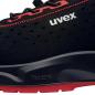 Preview: The image shows a modern, black shoe with red details. It has a textured surface with small holes for better breathability and a flexible sole.