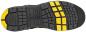 Preview: The image displays the sole of a sports shoe featuring a non-slip, textured pattern. The sole is predominantly black with yellow details that provide additional grip.