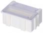 Preview: The image shows a rectangular, white plastic box with a transparent lid flap. It has four small feet and is slightly elevated in the center. The flap is open upwards.