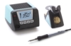 Preview: The image shows a soldering station. It consists of a black casing with blue accents, a digital display, a soldering tip, and a container for cleaning the tip.