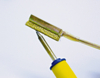 Preview: The image displays two specialized tools: a dustpan with a wide, flat edge and a brush with a yellow handle. Both are arranged on a light surface.