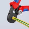 Preview: The image shows a wire cutter with red-blue handles. The cutter is holding green and yellow insulated wires. The cutting surface is black and features a circular recess.