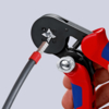 Preview: The image shows a cable cutter being held by a hand. It has red grip areas and a black working surface where a cable is being handled.