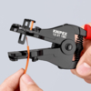 Preview: The image shows a cable cutter in a person's hand. The cutter is black and red in color and is holding a thin, orange cable that is being stripped.