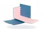 Preview: The image shows an L-shaped foam block with a rough, wavy surface in pink. It is surrounded by a blue cardboard and has a foldable structure.