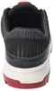 Preview: The image shows the back of a sports shoe. It is predominantly black with gray upper material and features a striking red sole. The structure is modern and functional.