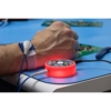 Preview: In the image, there is a hand working on a circuit board. Next to it, there is a round, glowing red button connected with wires.