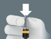 Preview: The image shows a hand in a white glove holding a screwdriver with a gray bit and a yellow handle. Above the hand is a downward-pointing arrow.