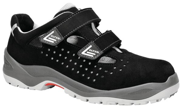 The shoe is black with gray accents, has two adjustable Velcro straps, and a perforated surface for ventilation. The sole is sturdy and designed to be slip-resistant.