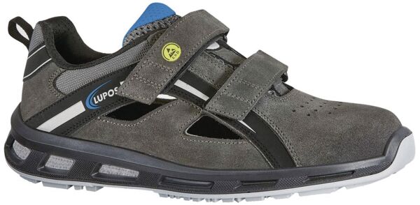 The shoe is a gray, sporty half-shoe with two Velcro fastenings. It has a comfortable, padded sole and noticeably reflective elements. The front is slightly perforated.