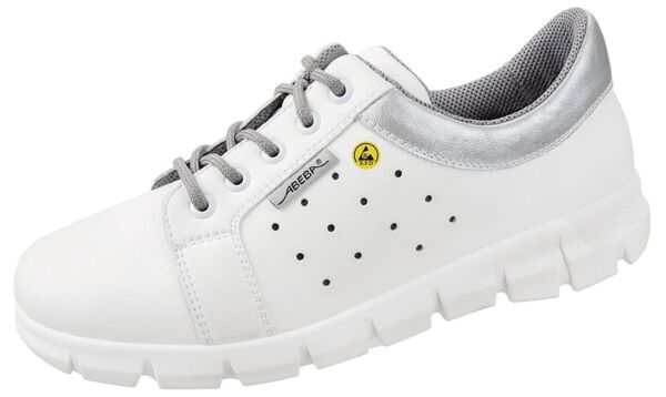 The shoe is white with silver accents. It has a flat sole and laces. The side features small holes for ventilation. The interior is lined with mesh material.