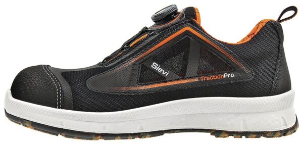 The shoe is black with orange accents, a sturdy front part, and a flexible, white sole area. It features a convenient quick-release system and breathable material.