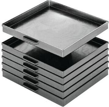 The image shows several black plastic trays stacked on top of each other. The top tray is slightly shifted and has two handles on the sides. The trays are smooth and have a slight shimmer.