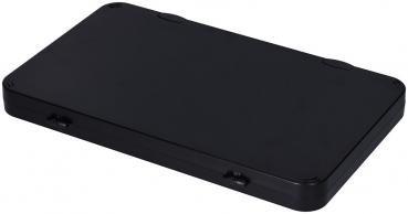 The image shows a flat, rectangular box in matte black. It has rounded corners and a smooth surface with two small openings on the short sides.