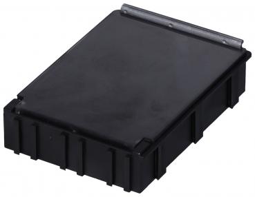 The image shows a rectangular, flat black box with a smooth lid and a small metal clasp. The sides are slightly raised and have a serrated pattern.