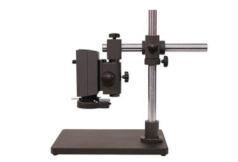 The image shows a device consisting of a sturdy base, two metal pillars, and a mount for lens-like elements. It is used for analysis or measurement.