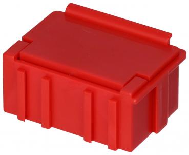 The image shows a small, rectangular box in bright red. It has a flat, rounded top with a grooved edge and vertical grooves on the sides.