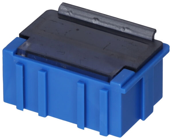 In the picture, there is a small, blue container. It has a black, flat top and vertical grooves on the sides. The container appears sturdy and compact.