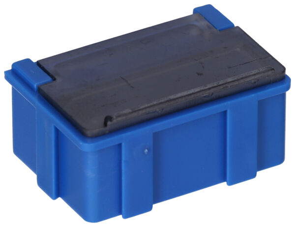 The image shows a small, rectangular box. It has a blue body and a black lid. The box has rounded edges on the sides and is equipped with a ribbed texture.