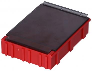 The image shows a rectangular object with a red plastic base and a smooth, gray or black top. The surface is flat and sits on a raised edge.