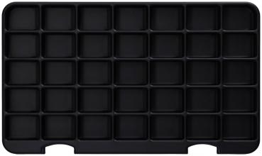 The image shows a black, rectangular tray with 36 small, square compartments. The compartments are evenly arranged and slightly raised. The background is uniformly black.