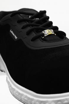 The shoe is black with a smooth surface. It has laces and a white rubber sole with texture. On the side is the brand name "LDMATRE".