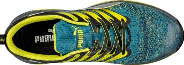 The image shows a sports shoe from above. It features a colorful upper in turquoise and yellow, with black laces and a sturdy, non-slip sole. The shoe is narrower at the forefront.