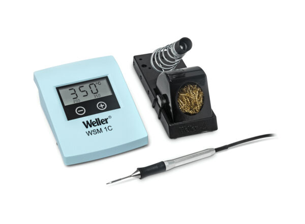 The image displays a soldering iron kit. It includes a digital thermometer with temperature display, a soldering iron with a rounded tip, and a holder with a cleaning wire.