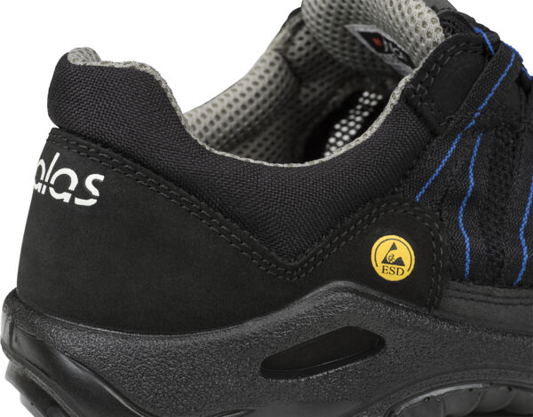 The image shows a black work shoe with blue accents. The shoe features a reinforced heel cap and a profiled sole that provides slip-resistant properties. An ESD symbol is visible.