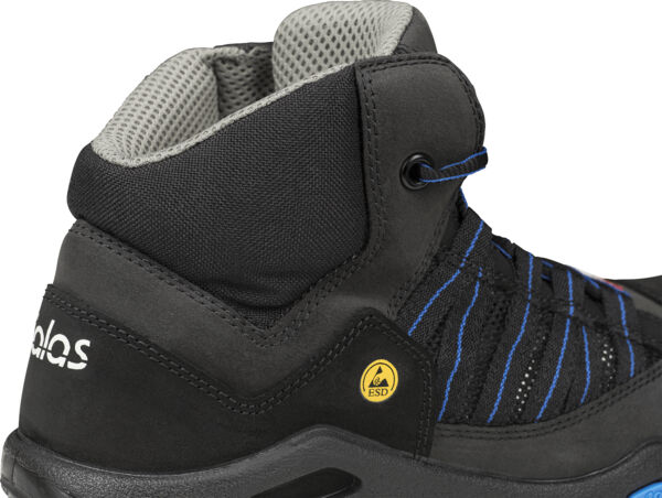 The image shows a black, ankle-high trail shoe. It has a textured surface, blue shoelaces, and a gray, padded upper edge. A yellow logo is visible on the heel area.