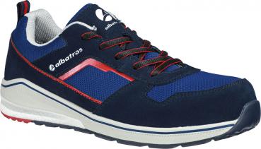 The shoe is sporty and colored in blue and gray. It has a fabric-covered upper, red accent lines, and a light gray, non-slip sole. Laces keep it secure.