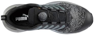 The shoe features a predominantly black upper with gray accents. The lacing has been replaced by a round mechanism at the center top. The sole is sturdy and slightly curved.