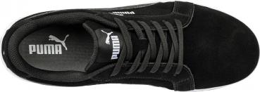 The image shows a black sneaker with a flat sole and classic laces. The Puma logo is clearly visible on the top. The fabric appears soft and flexible.