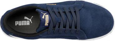 The image shows a blue sports shoe made from soft material. It has flat, continuous laces and the brand "Puma" is visible in golden lettering both inside and outside.