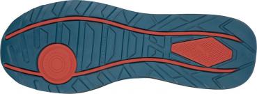 The image shows the sole of a shoe. It has a blue rubber pattern with red lines. The surface is textured, with a round and a rectangular area for better grip.